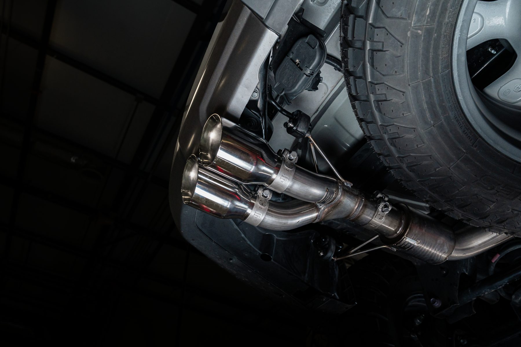 Milltek T304L stainless cat-back exhaust with dual polished tips on the Lexus GX 550, seen from underneath