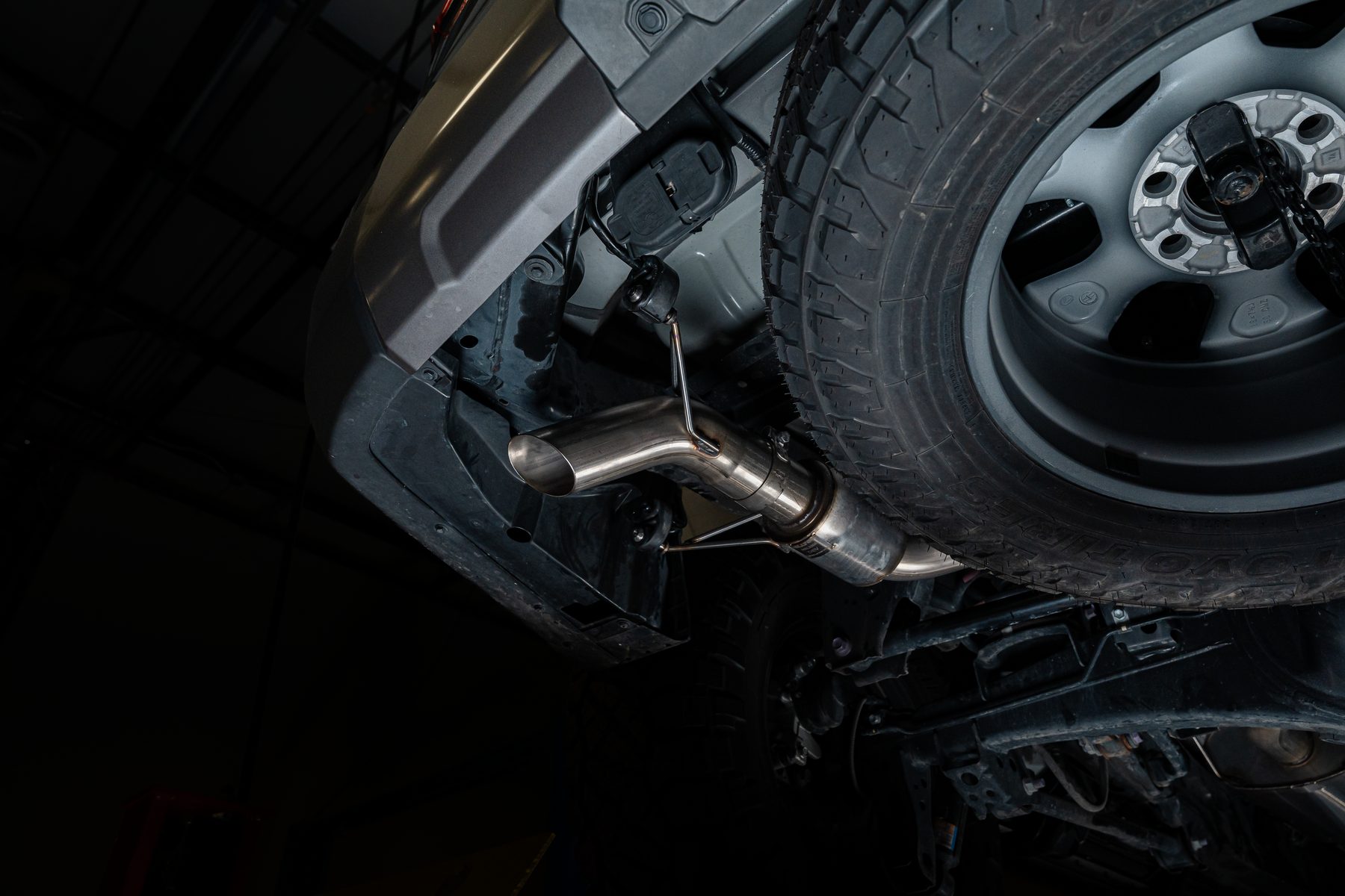 Milltek High Clearance cat-back on the Lexus GX 550, showing the over-axle section and tucked outlet beside the spare tire