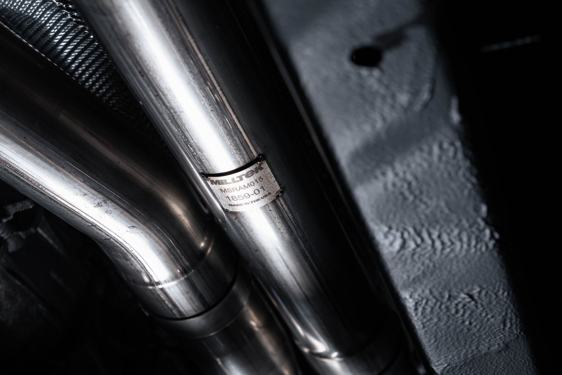 Close-up of 3 inch mandrel-bent T304L stainless Milltek pipework on the Ram 1500 RHO