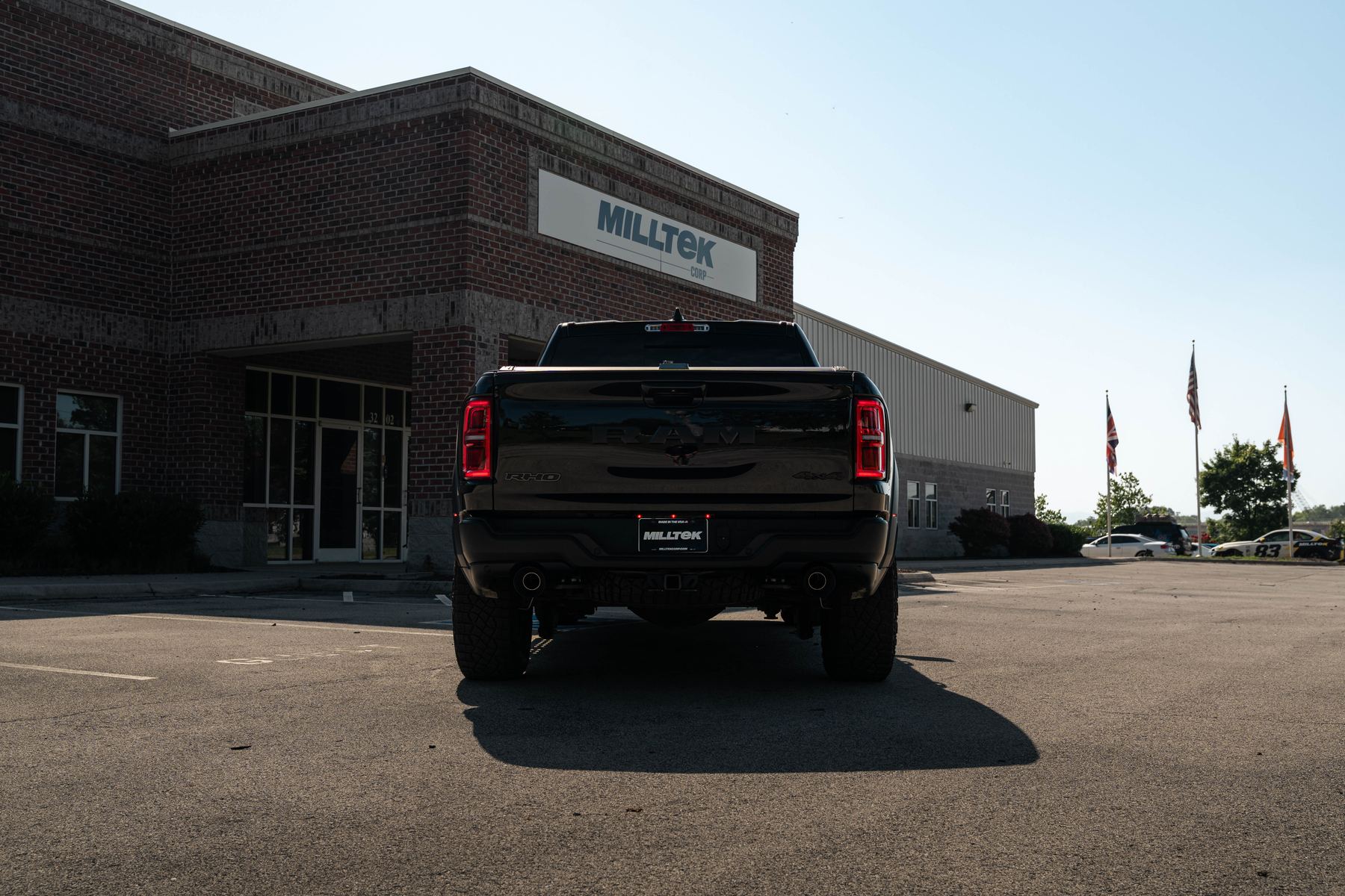 Rear of the Ram 1500 RHO with Milltek cat-back exhaust outside the Milltek Corp building